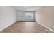 A bright living room with wood-look floors, fresh paint, decorative trim and a large window at 1323 Mifflin Ln, Dallas, NC 28034
