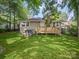 A cozy single-story home featuring a lush green lawn and a wooden deck perfect for outdoor entertaining at 144 Walnut St, Chester, SC 29706
