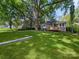 Expansive backyard with mature trees, green grass, and a wooden deck, providing a serene outdoor space at 144 Walnut St, Chester, SC 29706