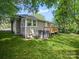 Exterior view of home and backyard features a small deck and shady spot for the AC unit at 144 Walnut St, Chester, SC 29706