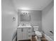 Bathroom featuring a neutral color palette, modern sink with a storage cabinet, and a toilet at 144 Walnut St, Chester, SC 29706