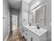 A bright bathroom featuring double sink vanity with sleek hardware, dual mirrors and modern lighting at 144 Walnut St, Chester, SC 29706