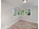 Bright bedroom with hardwood floors and plenty of natural light from the multiple windows at 144 Walnut St, Chester, SC 29706
