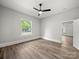 This bedroom features neutral walls, wood-look floors, a ceiling fan, and a window offering ample light at 144 Walnut St, Chester, SC 29706
