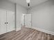 This bedroom boasts wood-look floors, neutral walls, two closets, and an open doorway to the next room at 144 Walnut St, Chester, SC 29706