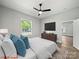 Staged bedroom features a ceiling fan, television, view of the exterior, and a modern interior design at 144 Walnut St, Chester, SC 29706