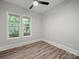 A bright bedroom with wood-look floors, two windows offering lush views, and neutral walls is move-in ready at 144 Walnut St, Chester, SC 29706