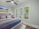 Beautifully staged bedroom with large windows letting in light, neutral walls, and plush bedding at 144 Walnut St, Chester, SC 29706