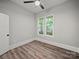 A quaint bedroom features wood-look floors, neutral walls, and two windows for natural light and views at 144 Walnut St, Chester, SC 29706