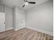 A clean bedroom features wood-look floors, neutral walls, and white trim with a modern ceiling fan at 144 Walnut St, Chester, SC 29706