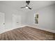 This bedroom features neutral walls, wood-look floors, a ceiling fan, and a window offering ample light at 144 Walnut St, Chester, SC 29706