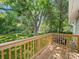 A wooden deck overlooking a lush green backyard with mature trees providing shade at 144 Walnut St, Chester, SC 29706