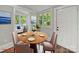 Cozy dining area featuring a round table, chairs, and natural light from windows at 144 Walnut St, Chester, SC 29706