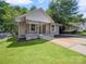 Charming home featuring a covered front porch, gray siding, and well-manicured lawn at 144 Walnut St, Chester, SC 29706