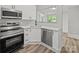 Well-appointed kitchen showcases stainless appliances, white countertops, and an open design at 144 Walnut St, Chester, SC 29706