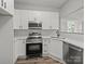 Bright kitchen boasts white cabinetry, stainless steel appliances, and a seamless countertop at 144 Walnut St, Chester, SC 29706
