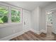 Room with wood floors, white trim, windows, and neutral walls at 144 Walnut St, Chester, SC 29706