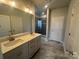 Bathroom with double vanity, decorative mirror, and tiled shower with glass door at 1459 Mocksville Hwy # 19, Statesville, NC 28625