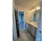 Bright bathroom featuring a double sink vanity with granite countertop, modern fixtures, and large mirrors at 1459 Mocksville Hwy # 19, Statesville, NC 28625