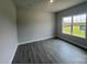 This well-lit bedroom features wood-look floors, neutral paint, and a large window for plenty of natural light at 1459 Mocksville Hwy # 19, Statesville, NC 28625