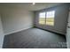 Bedroom features neutral walls, carpeted floor, window letting in natural light and white door at 1459 Mocksville Hwy # 19, Statesville, NC 28625