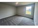 Well-lit bedroom featuring plush carpeting, neutral wall color, and a window providing ample natural light at 1459 Mocksville Hwy # 19, Statesville, NC 28625