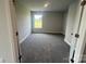 Cozy bedroom with neutral walls, plush carpeting, and a large window for great light exposure at 1459 Mocksville Hwy # 19, Statesville, NC 28625