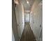 Hallway with neutral paint, wood-look floors, and doors leading to various rooms at 1459 Mocksville Hwy # 19, Statesville, NC 28625