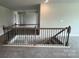 Upstairs landing with carpet and decorative dark wood railing overlooking the stairs at 1459 Mocksville Hwy # 19, Statesville, NC 28625