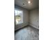 A bright laundry room with tile flooring, a window, and hook-ups for a washer and dryer at 1459 Mocksville Hwy # 19, Statesville, NC 28625