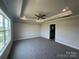 Bright main bedroom with tray ceiling, carpet flooring, ceiling fan, and natural light at 1459 Mocksville Hwy # 19, Statesville, NC 28625