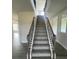 Carpeted staircase with decorative wood railing and natural light at 1459 Mocksville Hwy # 19, Statesville, NC 28625