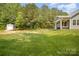 Expansive backyard featuring lush lawn, a storage shed, and a covered porch area for relaxing at 148 Powder Spring Dr, Statesville, NC 28677