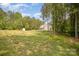 Secluded backyard with a storage shed surrounded by mature trees at 148 Powder Spring Dr, Statesville, NC 28677