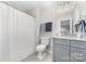 Clean bathroom with a shower and tub, gray vanity, and neutral wall colors at 148 Powder Spring Dr, Statesville, NC 28677