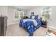 Bright bedroom featuring large windows, carpet floors, and a blue comforter at 148 Powder Spring Dr, Statesville, NC 28677