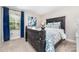 Elegant bedroom with dark wood bed frame, blue floral bedding, and natural light from the window at 148 Powder Spring Dr, Statesville, NC 28677