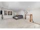 Comfortable bonus room features plush carpeting, a sectional sofa, and abundant natural light, perfect for relaxation at 148 Powder Spring Dr, Statesville, NC 28677