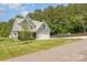 Two-story home with manicured lawn, mature trees, and a two-car garage at 148 Powder Spring Dr, Statesville, NC 28677