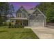 Charming two-story home with a well-manicured lawn, inviting front porch, and a two car garage at 148 Powder Spring Dr, Statesville, NC 28677