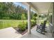 Inviting front porch with rocking chairs and a view of the landscaped front yard at 148 Powder Spring Dr, Statesville, NC 28677