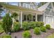 Inviting front porch featuring stylish seating and lush landscaping at 148 Powder Spring Dr, Statesville, NC 28677