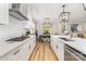 Bright kitchen with stainless appliances, white cabinets, and view to the dining area at 148 Powder Spring Dr, Statesville, NC 28677
