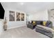 Cozy living room features comfortable gray sectional couch, ottoman and decorative world map art at 148 Powder Spring Dr, Statesville, NC 28677