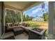 Covered outdoor patio with comfortable seating and a fire pit, perfect for entertaining guests at 148 Powder Spring Dr, Statesville, NC 28677