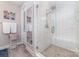Stylish bathroom features a glass enclosed shower with subway tile and tiled floors at 148 Powder Spring Dr, Statesville, NC 28677