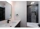 Modern bathroom with sleek vanity, stylish mirror, and beautifully tiled shower and tub area at 1520 Enochville Rd, Kannapolis, NC 28081