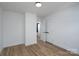 Bright bedroom features wood-look floors and a closet and doorway into the rest of the home at 1520 Enochville Rd, Kannapolis, NC 28081