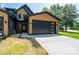 Modern two-story home with black garage door, natural wood accents and manicured lawn at 1520 Enochville Rd, Kannapolis, NC 28081
