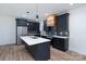 Well-lit kitchen with stainless steel appliances, a large island, and modern hanging light fixtures at 1520 Enochville Rd, Kannapolis, NC 28081